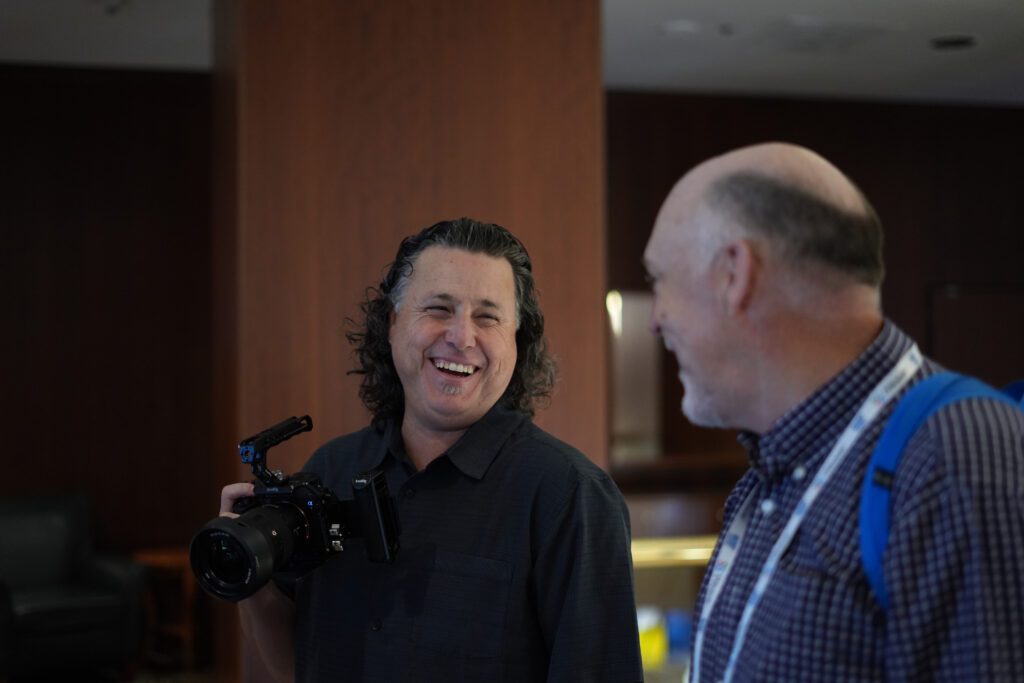 Film production extraordinaire, Kasey Atkins, on set with Robert Johnston, filming interviews at the AAQEP conference.
